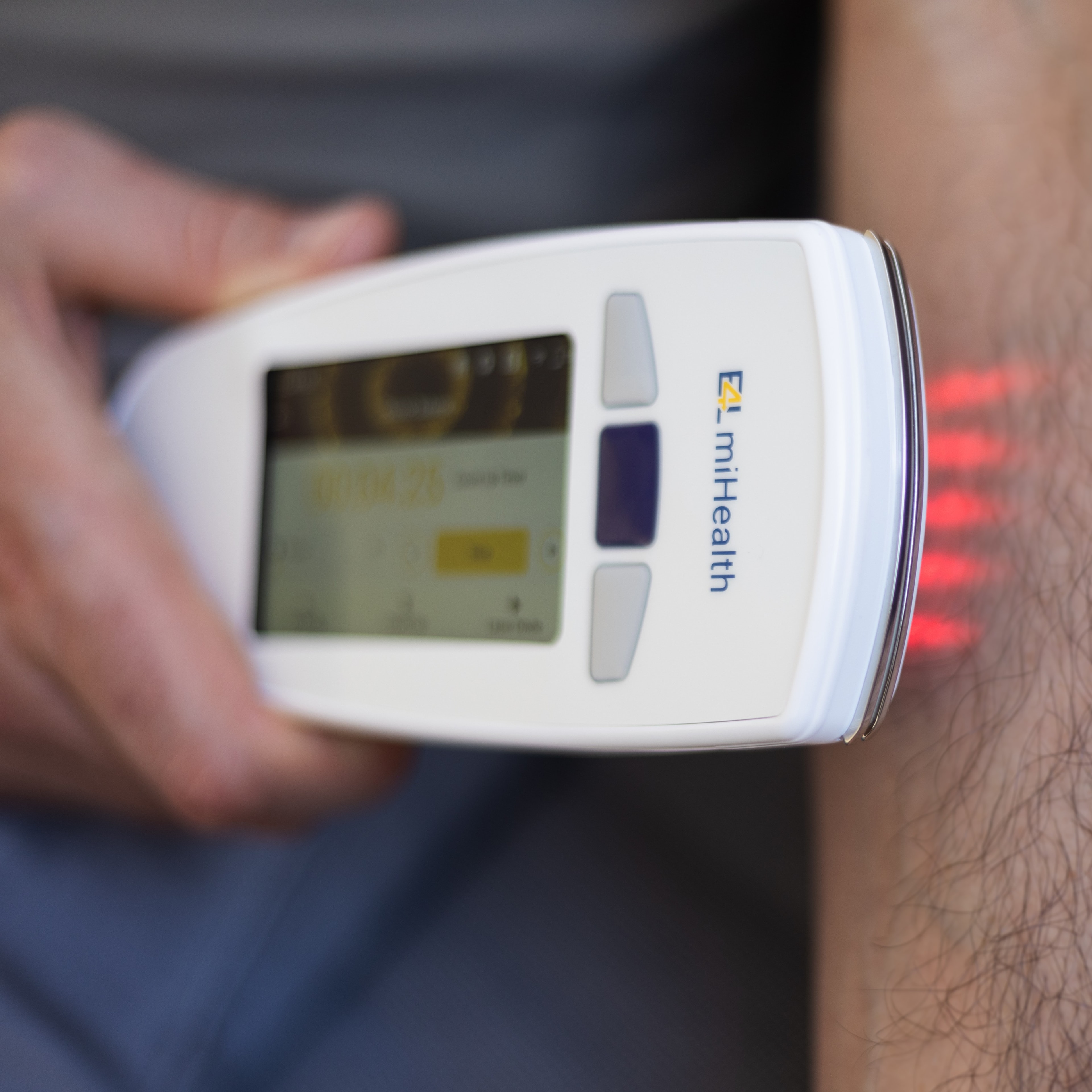 miHealth device being used in a laser therapy session